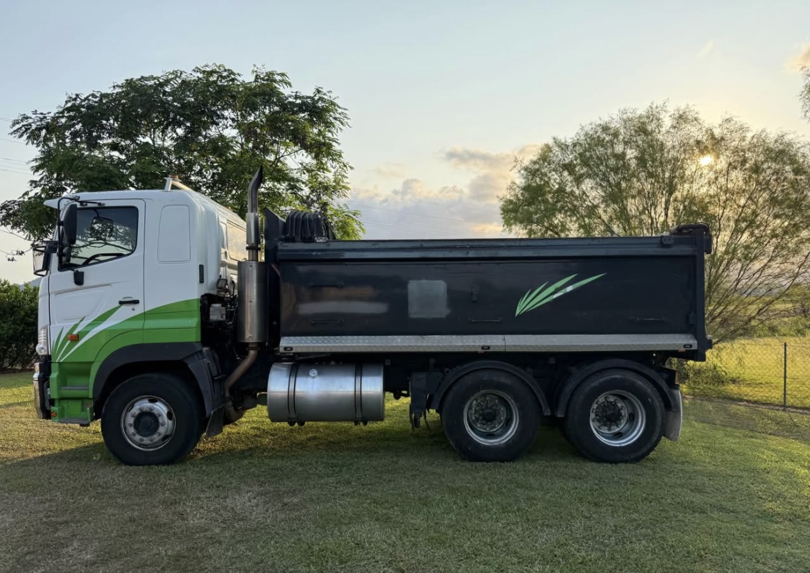 Side profile of the green tipper truck ready for work